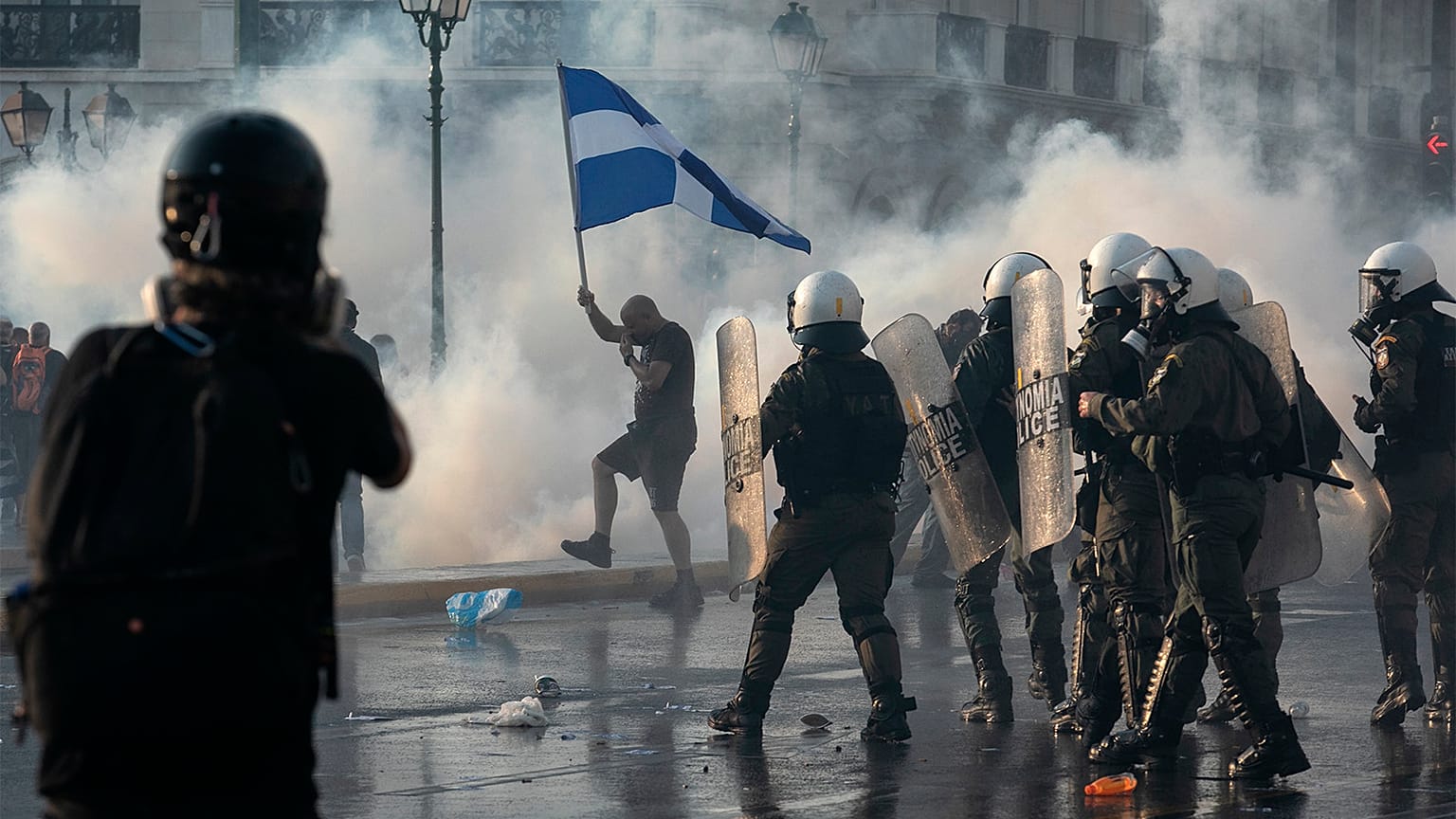 Greek police use tear gas to disperse anti-vaccine protesters during a rally at Syntagma square, central Athens, on Wednesday, July 21, 2021