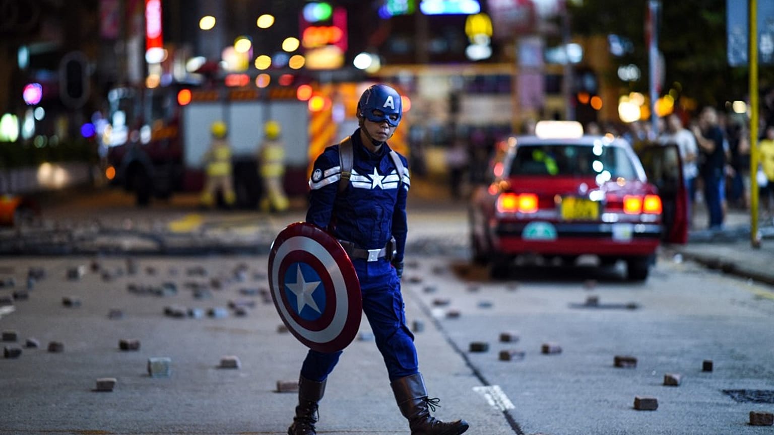 A man wearing a Captain America costume walks near the Mong Kok police station in Hong Kong in October 2019.