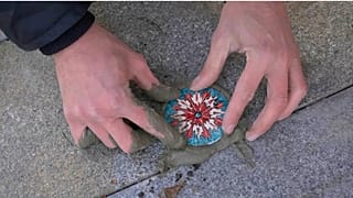 Ivan Kravchenko produces small painted fillings for Russia's many untreated potholes