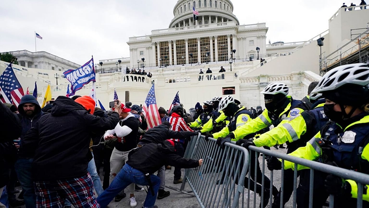 Trump supporters try to break through a police barrier at the Capitol on Jan. 6, 2021