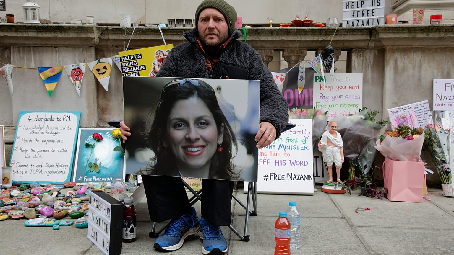 Richard Ratcliffe, husband of Nazanin Zaghari-Ratcliffe, holds up a picture of his wife as he continues his hunger strike outside Britain's Foreign Office on Nov. 11, 2021.