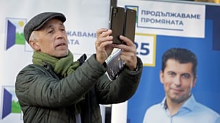 A supporter of the Political Party "We Continue the Change" takes pictures during an event in central Sofia, Wednesday, Nov. 10, 2021.