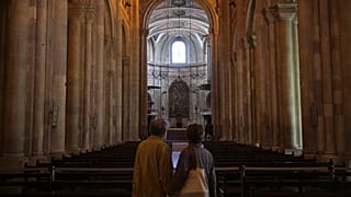 A couple visit the Lisbon Cathedral.