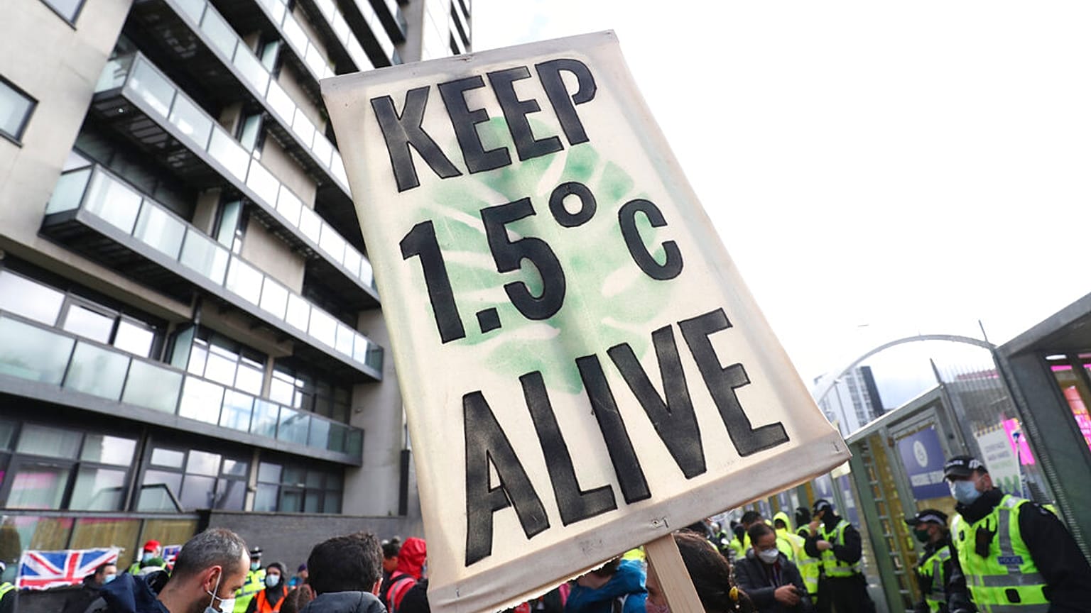 A placard reminds world leaders of their climate commitments at a COP26 demonstration in Glasgow on Friday