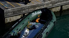A dingy is moved from a British Border Force patrol boat in Dover harbour.