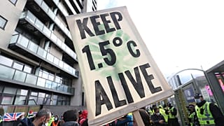 Climate activists take part in a demonstration outside the venue of the COP26 U.N. Climate Summit in Glasgow, Scotland, Friday, Nov. 12, 2021. 