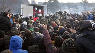 Belarusian servicemen shown while migrants gather at the Belarus-Poland border near Grodno, Belarus, Friday, Nov. 12, 2021.