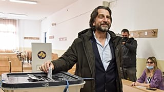 Përparim Rama, centre, candidate for the mayor from Democratic League of Kosovo, (LDK), casts his vote in Pristina, Kosovo, on Sunday, Nov. 14, 2021