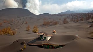 A house is covered by ash from a volcano as it continues to erupt on the Canary island of La Palma