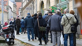 People wait in a long line to be vaccinated against the coronavirus during a vaccination campaign of the DRK, German Red Cross, in front of the town hall in Pirna, Germany.