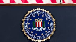 This June 14, 2018 file photo shows an FBI seal on a podium before a news conference at the agency's headquarters in Washington.