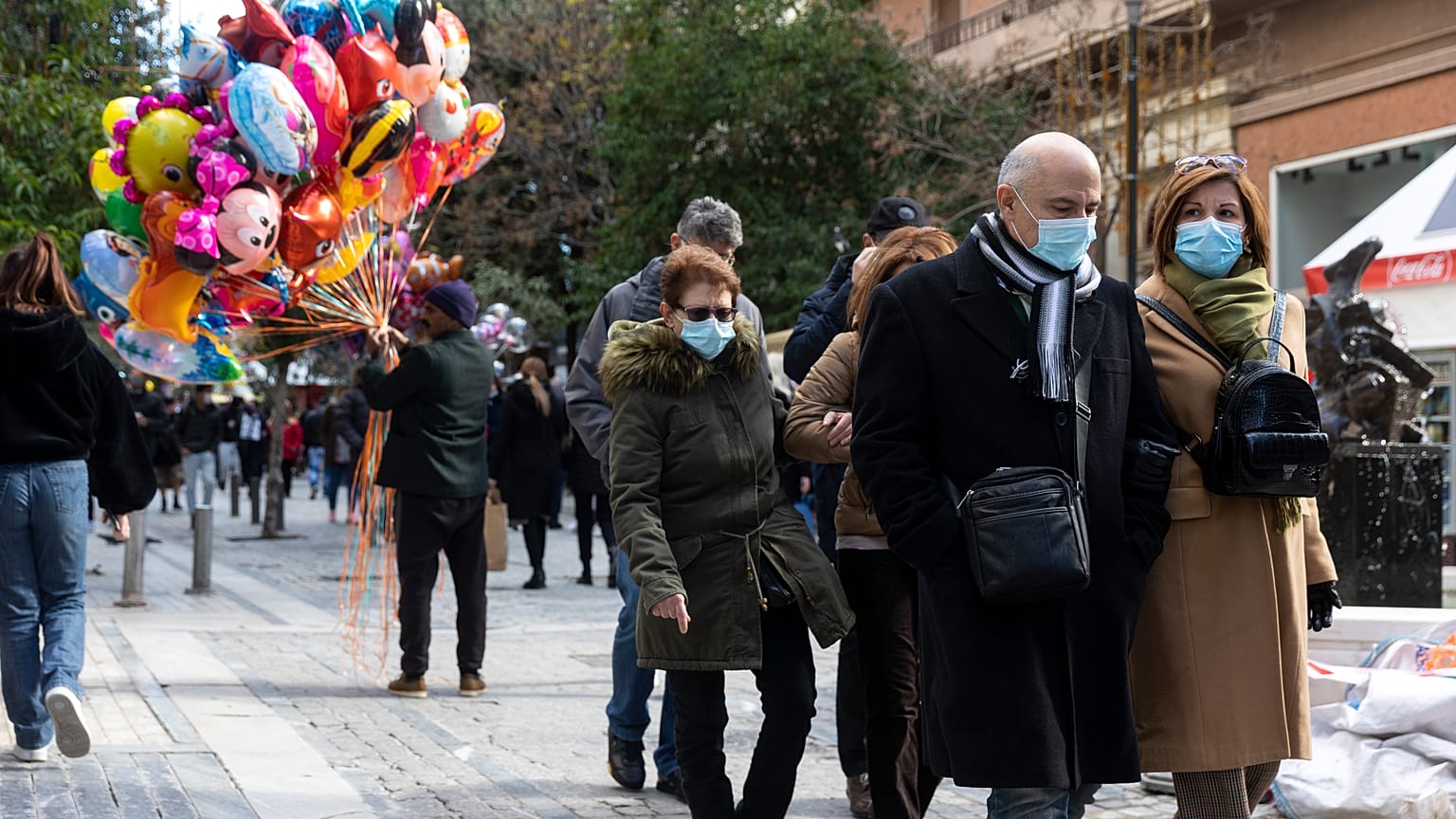 People make their way at a central market street in Athens, Sunday, Dec.19, 2021. 