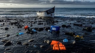 a wooden boat used by migrants from Morocco sits on the shore on the coast of the Canary Island of Gran Canaria, Spain, Oct. 16, 2020.
