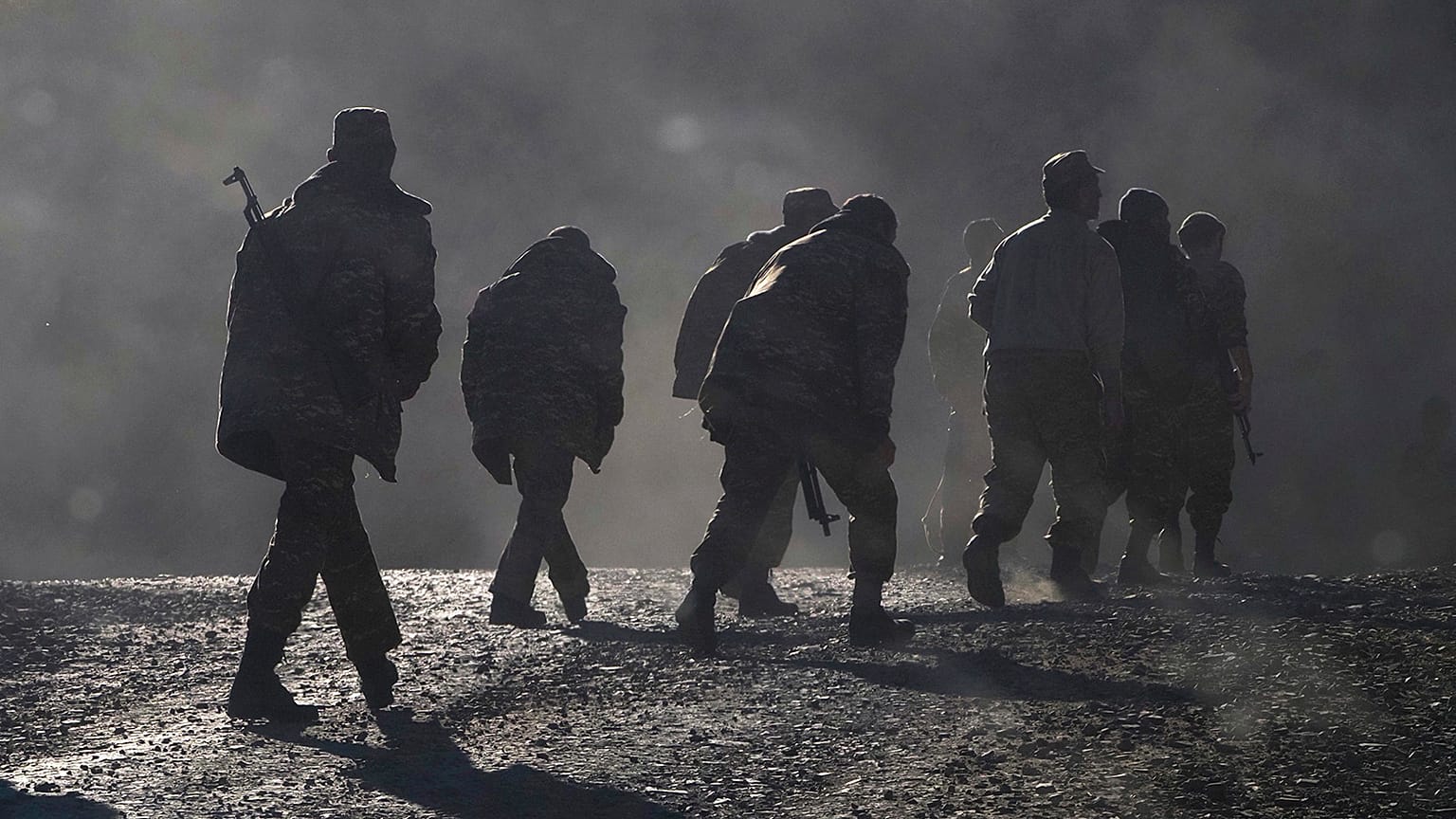 ethnic Armenian soldiers walk along the road during a military conflict against Azerbaijan's forces in Nagorno-Karabakh.