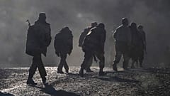 ethnic Armenian soldiers walk along the road during a military conflict against Azerbaijan's forces in Nagorno-Karabakh.