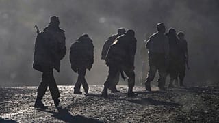 ethnic Armenian soldiers walk along the road during a military conflict against Azerbaijan's forces in Nagorno-Karabakh.