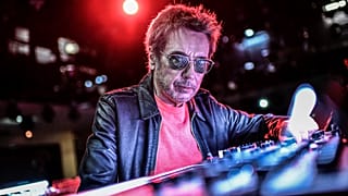 French composer and producer Jean-Michel Jarre poses on stage prior to perform a 2021 New Year's Eve virtual reality concert "Welcome to the other side"