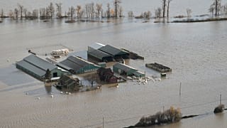 A farm is surrounded by floodwaters in Abbotsford, British Columbia, Tuesday, Nov. 16, 2021.