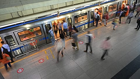 Commuters board the metro at a station after the services were allowed to operate at 50 percent capacity in New Delhi on June 7, 2021