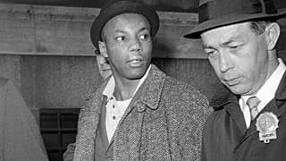 FILE — Norman 3X Butler, 26, a suspect in the slaying of Malcolm X, is escorted by detectives at police headquarters, after his arrest, in New York, Feb. 26, 1965.