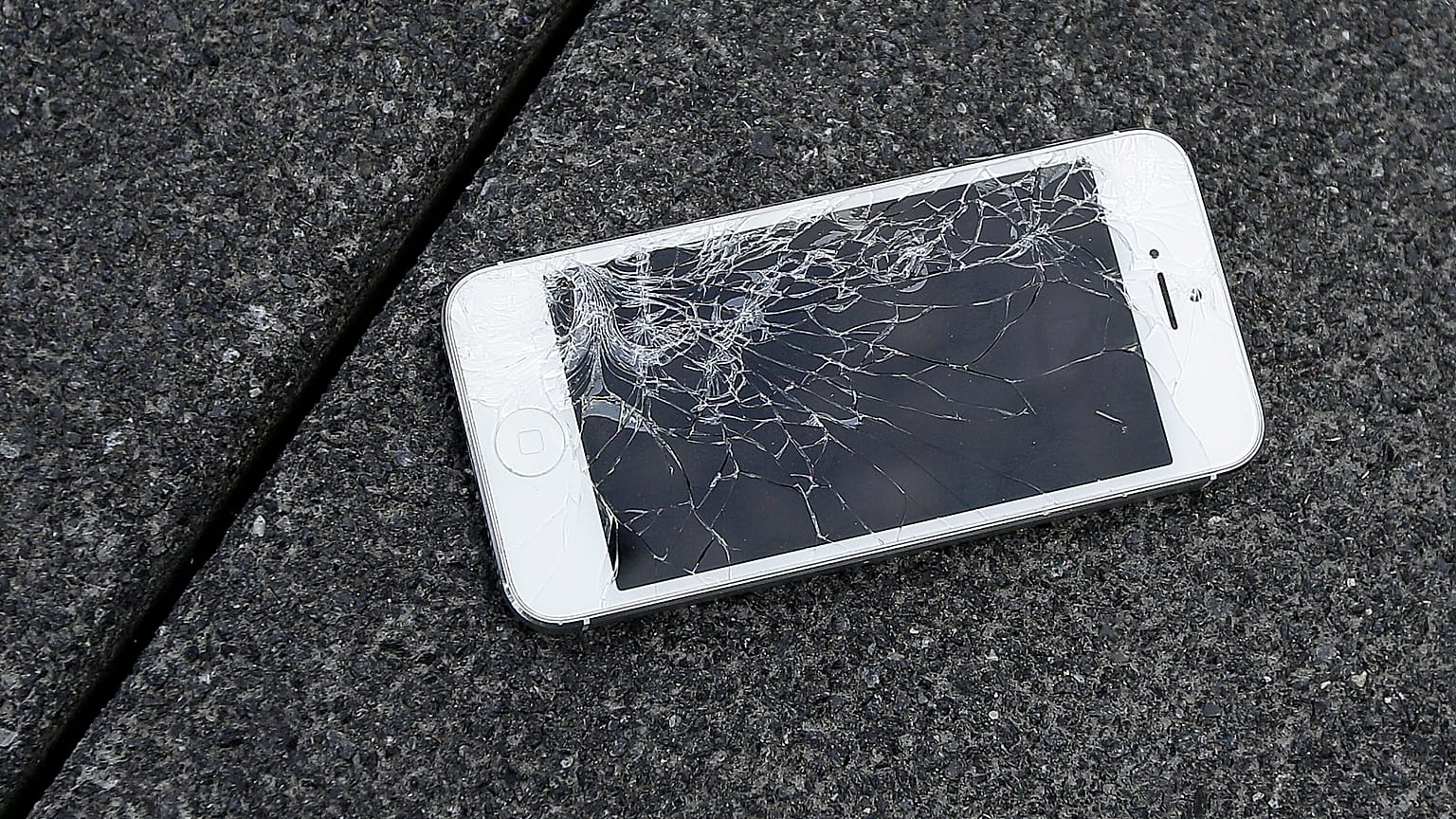 This Aug. 26, 2015 photo shows an Apple iPhone with a cracked screen after a drop test from the DropBot.