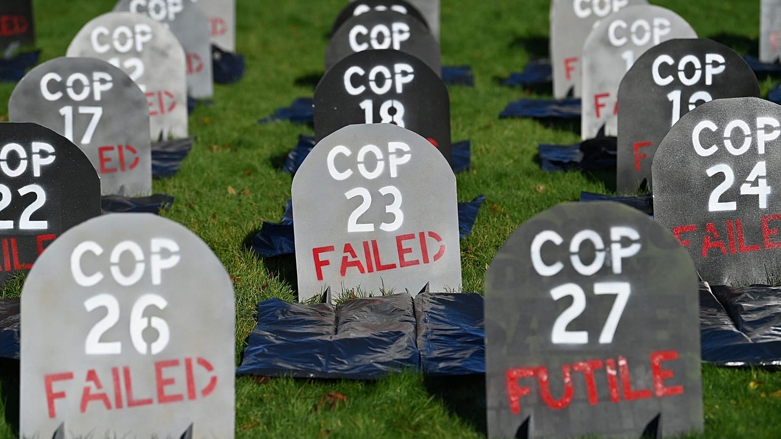 Mock headstones are pictured at Glasgow Necropolis to symbolise the failure of the COP26 process, at Glasgow Cathedral in Glasgow on November 13, 2021.