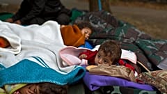 FILE: Yazidi refugee children from Mosul, Iraq, sleep with their family near an abandoned military barrack in Beli Manastir, northeast Croatia, Saturday, Sept. 19,2015. 