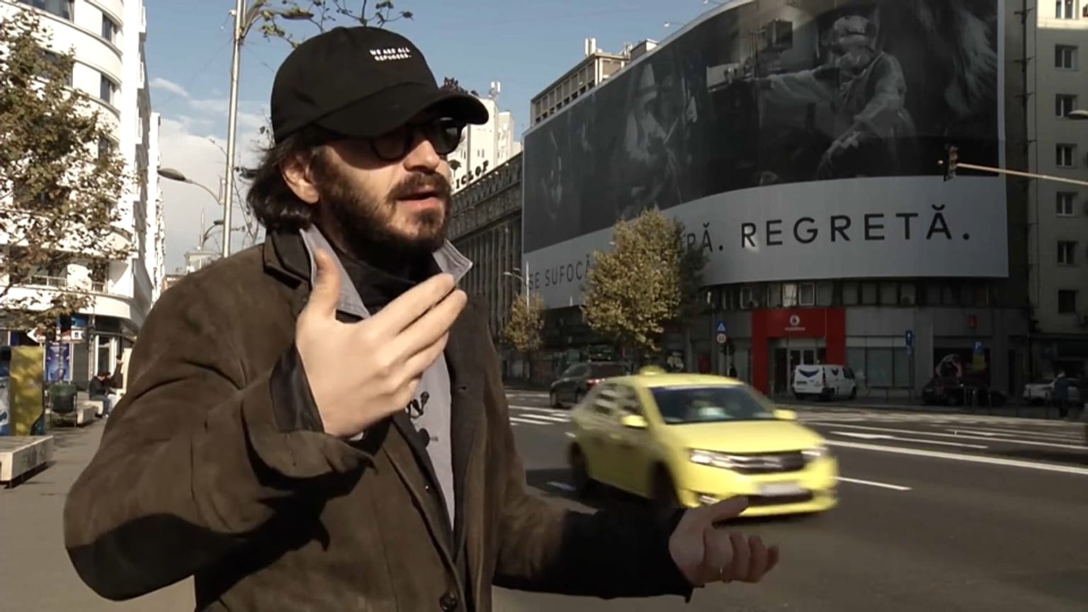 Photographer Cristian Movilă in front of his slogan 'They suffocate. They implore. They regret'. 
