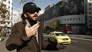 Photographer Cristian Movilă in front of his slogan 'They suffocate. They implore. They regret'.