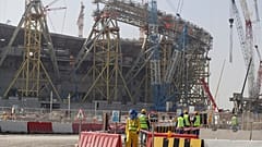 File photo: Workers walk to the Lusail Stadium, one of the 2022 World Cup stadiums, in Lusail, Qatar