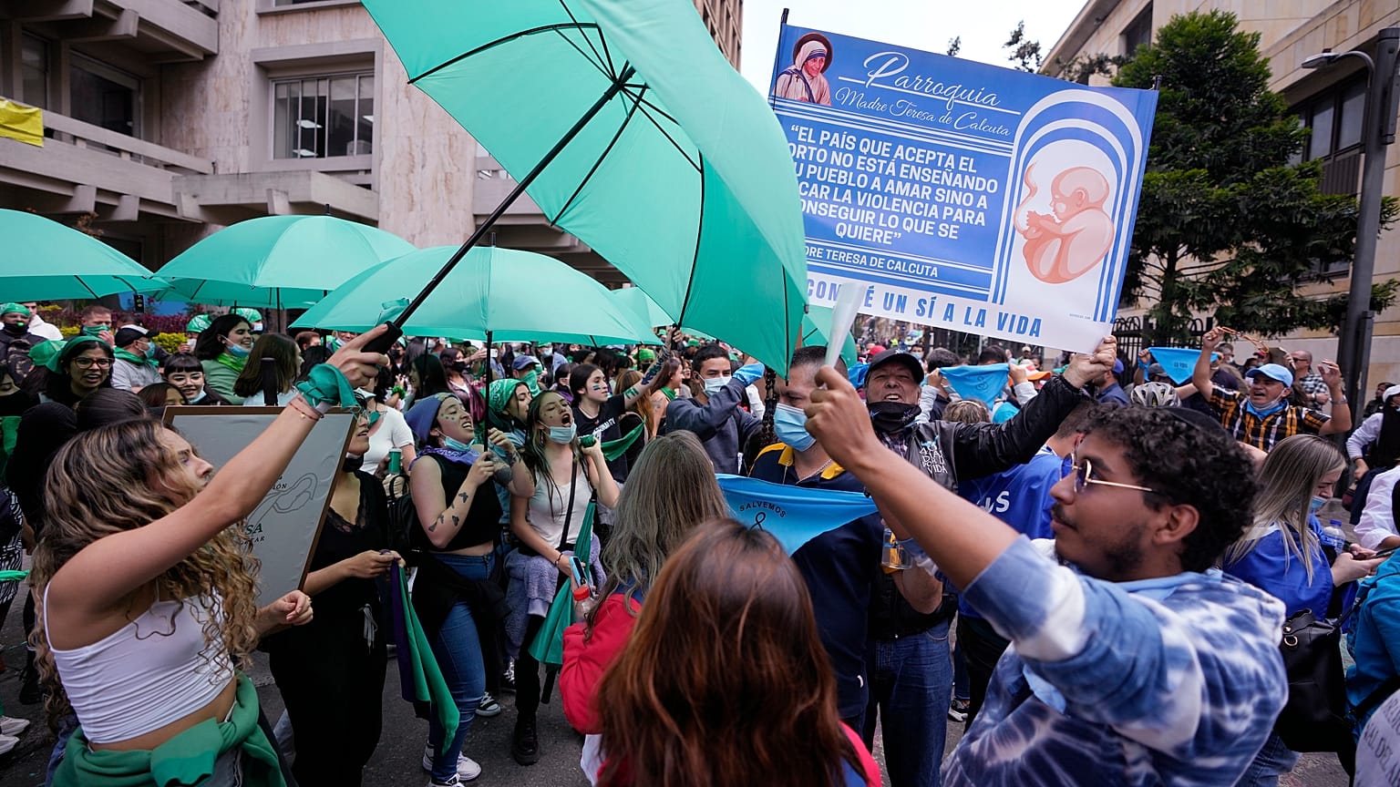 Abortion-rights activists (L), and anti-abortion activists protest outside the Constitutional Court as judges review a lawsuit that seeks to decriminalize abortion in Bogota.