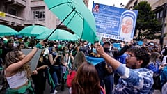 Abortion-rights activists (L), and anti-abortion activists protest outside the Constitutional Court as judges review a lawsuit that seeks to decriminalize abortion in Bogota.