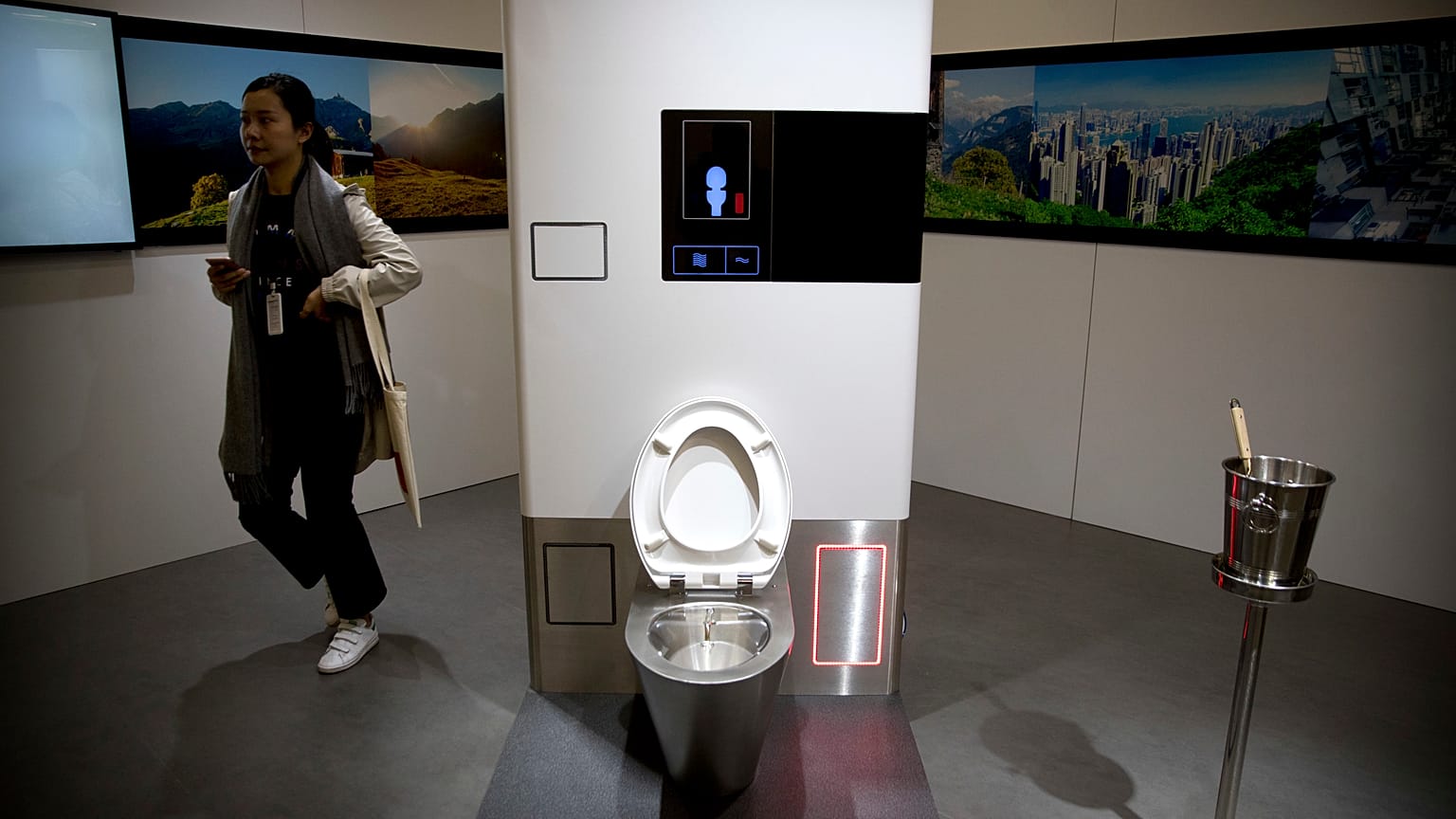 A visitor looks at a display at the Reinvented Toilet Expo in Beijing, Tuesday, Nov. 6, 2018. 