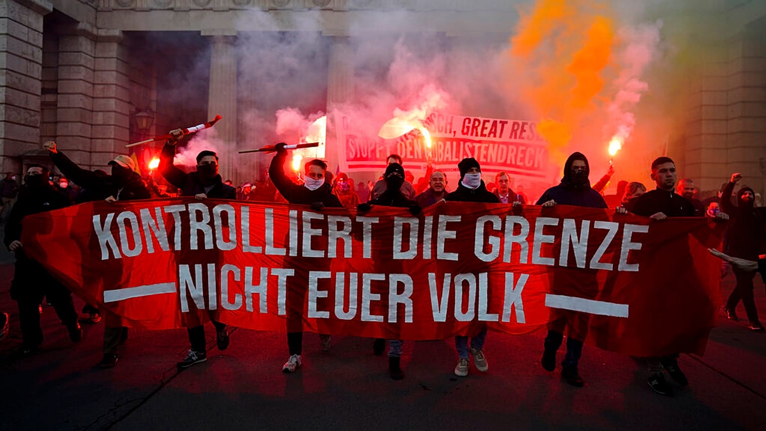 Demonstrators shout slogans and light flares during a demonstration against measures to battle the coronavirus pandemic in Vienna, Austria, Saturday, Nov. 20, 2021.