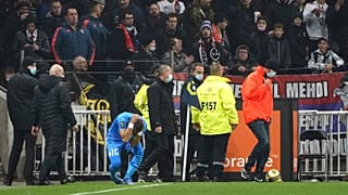 Marseille's Dimitri Payet reacts after being injured by an object thrown by a Lyon supporter 