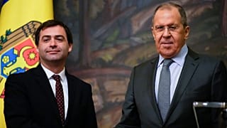 Russian Foreign Minister Sergey Lavrov, right, and his Moldovan counterpart Nicu Popescu shake hands 17 November 2021.