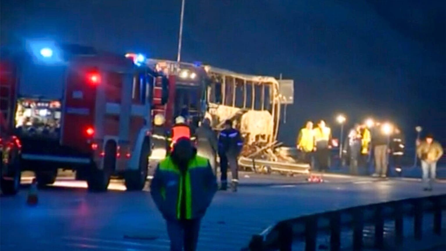 This image made from video provided by Nova TV shows emergency service workers beside a burnt out bus with emergency services in Bosnek, Bulgaria