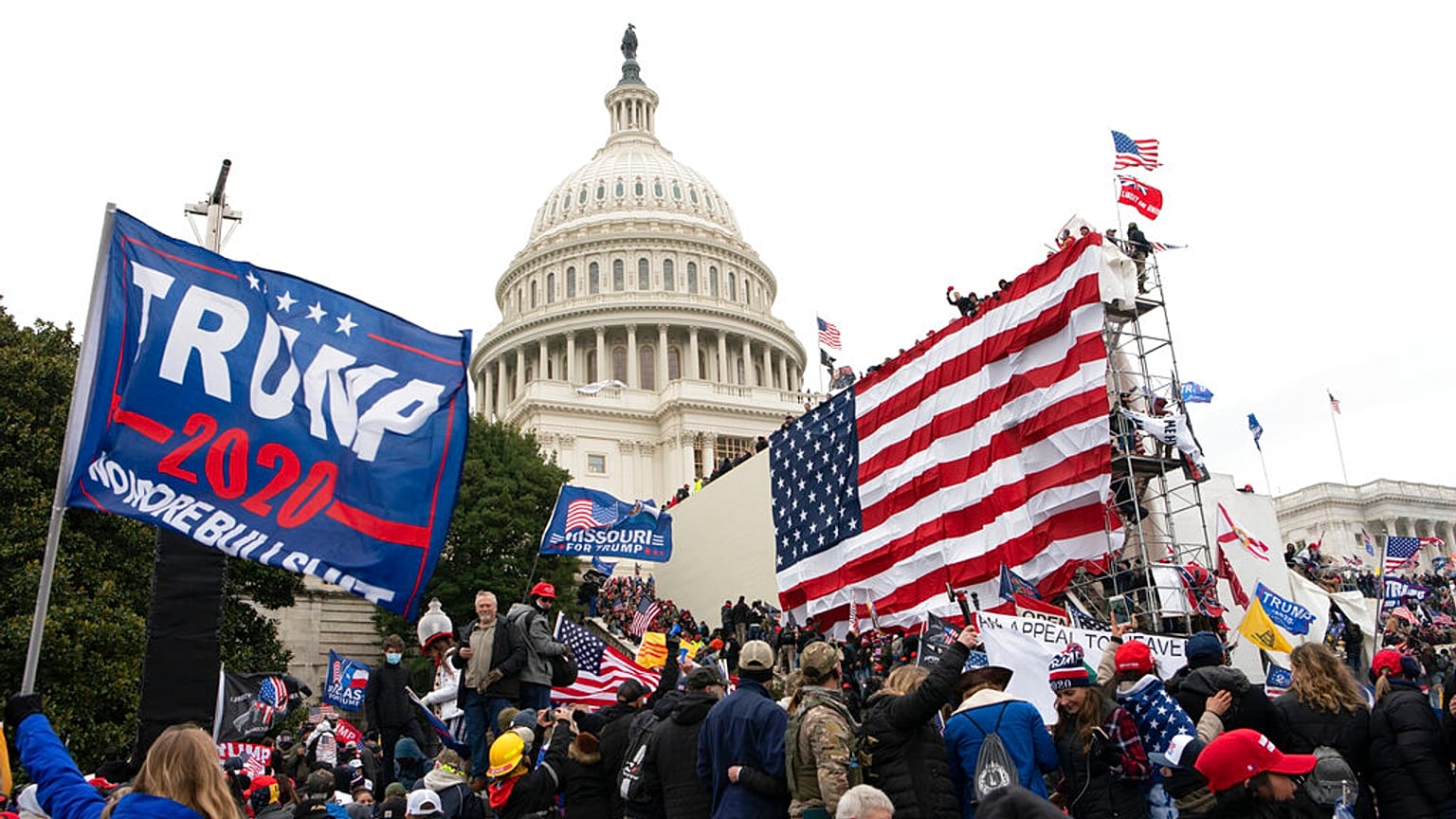 Violent insurrectionists loyal to President Donald Trump stand outside the U.S. Capitol in Washington on Jan. 6, 2021