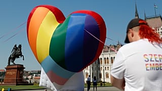 Activists display a large rainbow heart in front of Hungary's parliament building in Budapest in July.