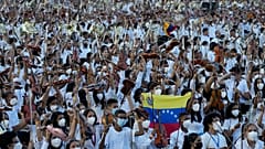 Members of the National Orchestra System raise their instruments after they played a 12-minute Piotr's Slavic March Ilich Tchaikovsky in Caracas, Venezuela, on Nov. 13, 2021.
