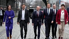 Germany's new coalition leaders arrive at a press conference in Berlin. SPD candidate Olaf Scholz, expected to become chancellor, is centre.