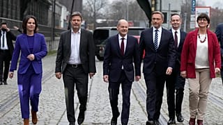 Germany's new coalition leaders arrive at a press conference in Berlin. SPD candidate Olaf Scholz, expected to become chancellor, is centre.