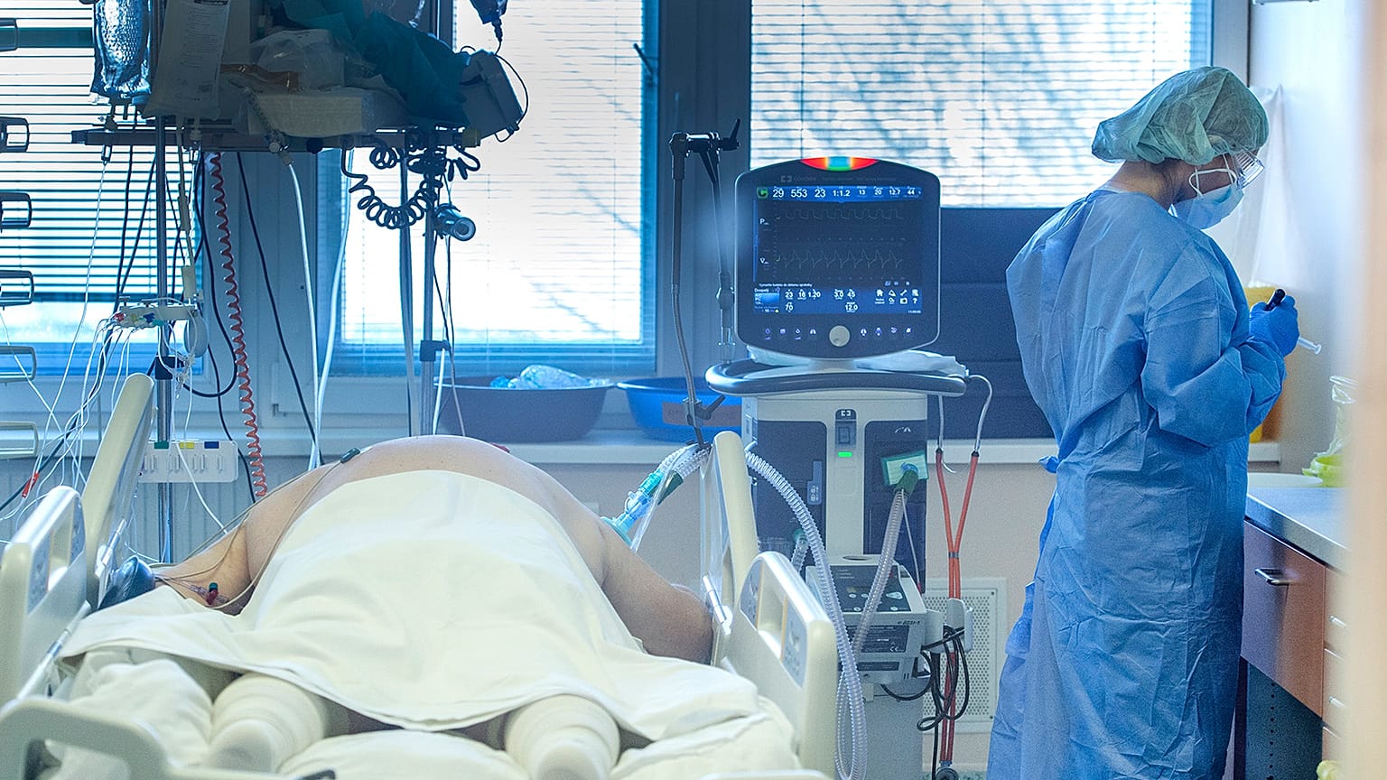 Medical staff attend to a patient at the COVID-19 ICU unit of the hospital in Bratislava, Slovakia, Tuesday, Nov. 23, 2021.