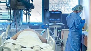 Medical staff attend to a patient at the COVID-19 ICU unit of the hospital in Bratislava, Slovakia, Tuesday, Nov. 23, 2021.