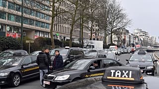 FILE: Taxi drivers use their vehicles to block roads on the inner ring of Brussels during a protest against general taxi regulations and Uber, Tuesday, March 27, 2018.