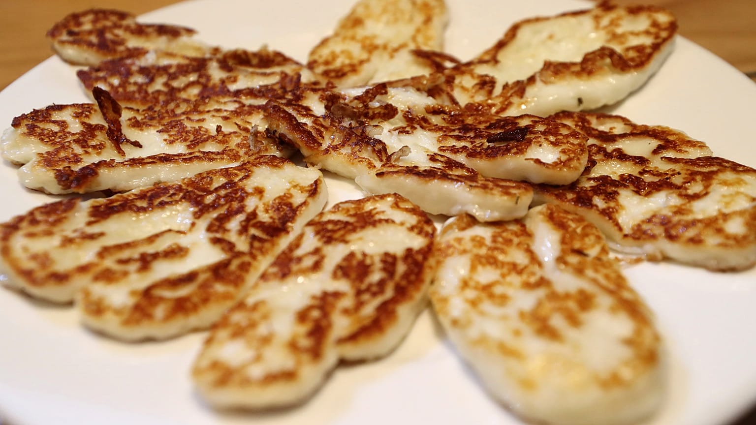 In this Wednesday Dec. 11, 2019 file photo, Cyprus' halloumi cheese is seen roasted on a plate at "Riverland" farm in Kampia village near Nicosia, Cyprus.