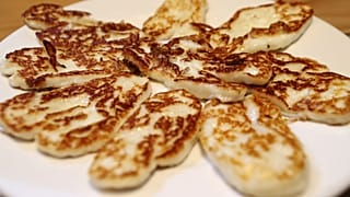In this Wednesday Dec. 11, 2019 file photo, Cyprus' halloumi cheese is seen roasted on a plate at "Riverland" farm in Kampia village near Nicosia, Cyprus.