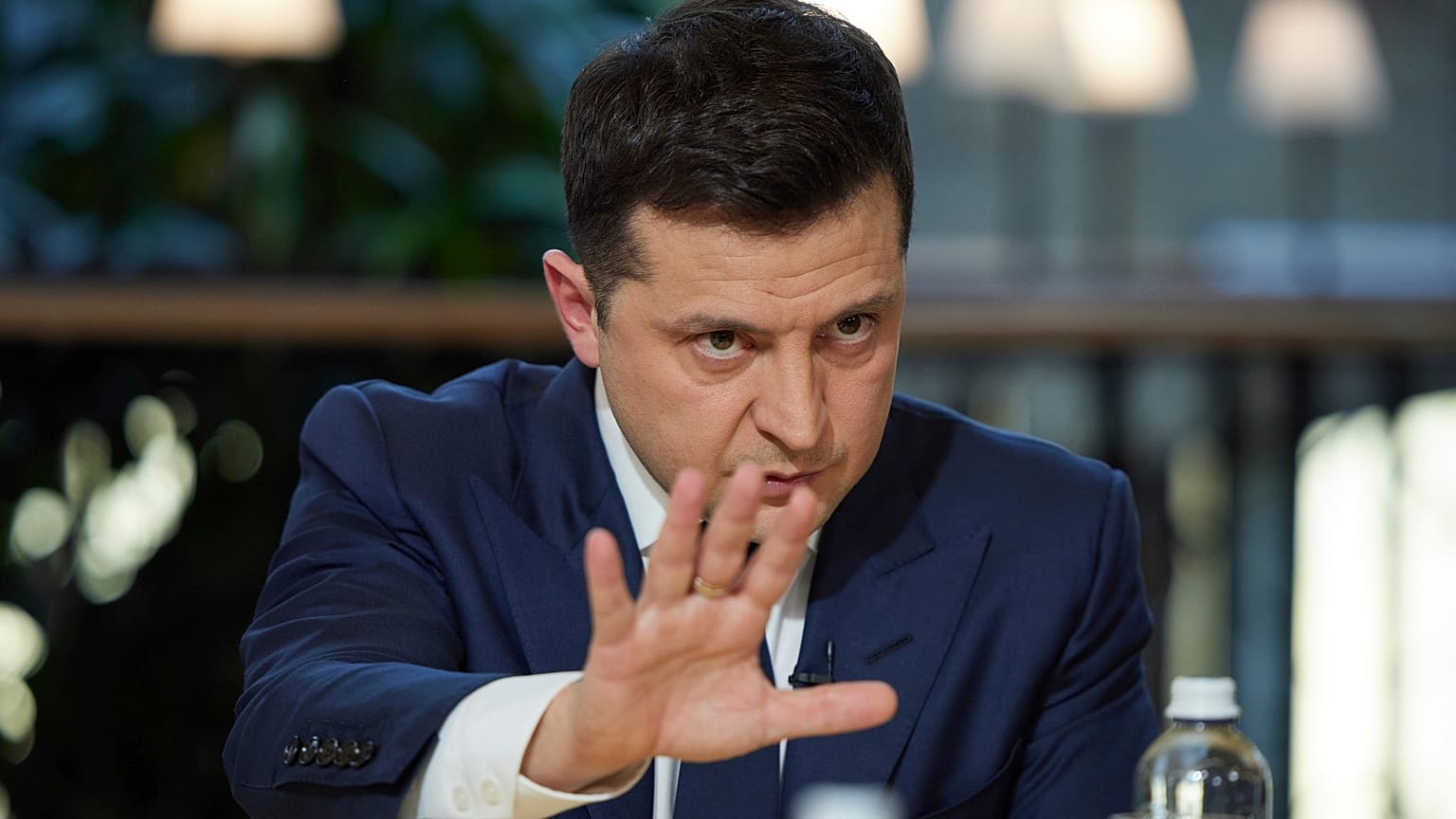 Ukrainian President Volodymyr Zelenskyy gestures while speaking to the media during a news conference in Kyiv.
