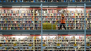 In this Nov. 19, 2015 file photo an employee works in the distribution center of the online retailer Amazon in Leipzig, central Germany.