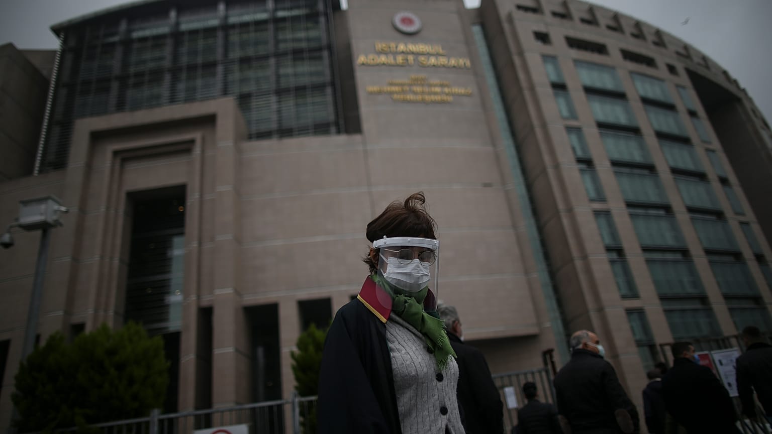 A lawyer arrives at the court in Istanbul Friday, Dec. 18, 2020 to attend the opening hearing of a new trial against jailed Turkish businessman, philanthropist Osman Kavala.